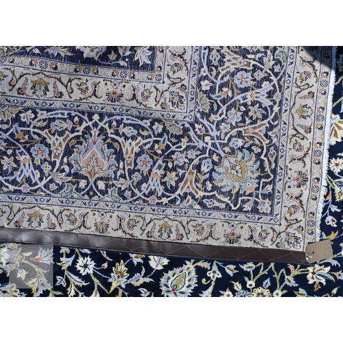 465 - A contemporary central Persian Kashan carpet, signed by the weaver, the blue ground with flowering v... 