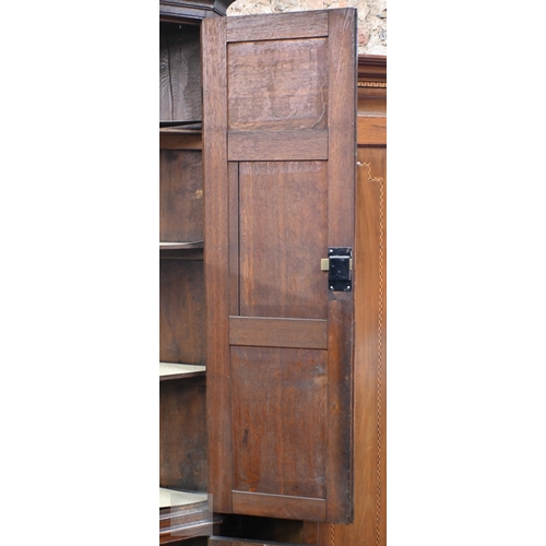 51 - A George III oak full height corner cupboard, the upper pair of triple framed panelled doors over tw... 
