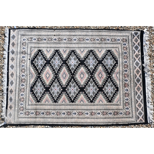 54 - Two Indo-Persian part silk Kashan rugs, traditional floral designs on blue-black ground, mid-20th ce... 