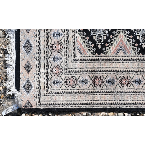 54 - Two Indo-Persian part silk Kashan rugs, traditional floral designs on blue-black ground, mid-20th ce... 
