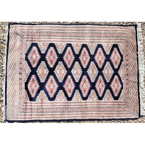 54 - Two Indo-Persian part silk Kashan rugs, traditional floral designs on blue-black ground, mid-20th ce... 