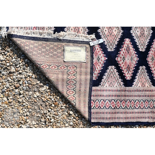 54 - Two Indo-Persian part silk Kashan rugs, traditional floral designs on blue-black ground, mid-20th ce... 