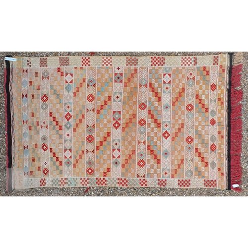 56 - A vintage handloomed Portuguese 'Turkish Soumak' design rug, in soft multi-colours, 180 cm x 106 cm