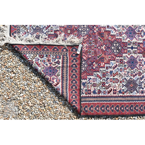 57 - A Persian Kashqai kelim, the camel ground with geometric designs, 202 cm x 106 cm