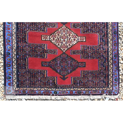 58 - A contemporary North West Persian Senneh runner, the red ground with geometric pole design, 320 cm x... 