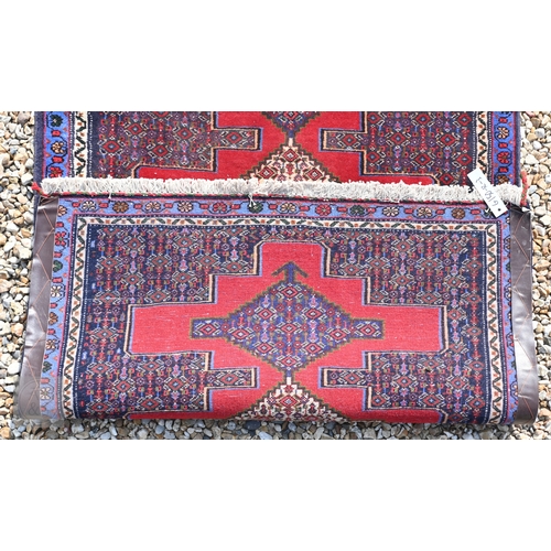 58 - A contemporary North West Persian Senneh runner, the red ground with geometric pole design, 320 cm x... 