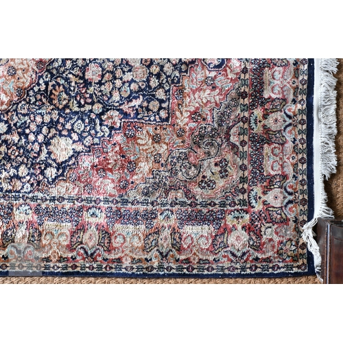 59 - An Indo-Persian Kashan rug, the blue/crimson ground centred by a medallion, 180 cm x 124 cm