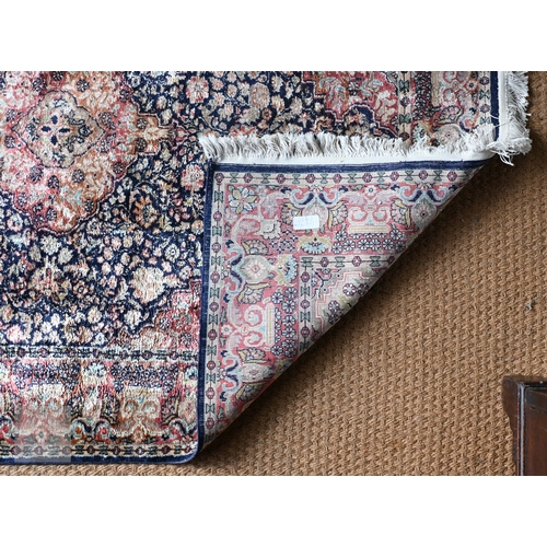 59 - An Indo-Persian Kashan rug, the blue/crimson ground centred by a medallion, 180 cm x 124 cm
