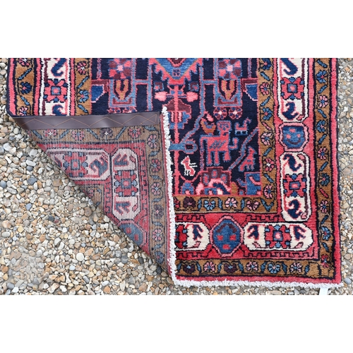 60 - A contemporary Persian Navahand/Hamadan wide runner, the geometric design on blue/crimson ground, 29... 