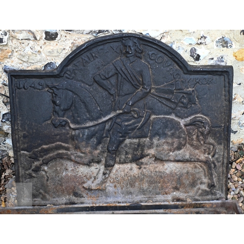 9 - A large cast iron fireback with arched top and relief of a mounted cavalier dated 1649, 84 cm x 67 c... 