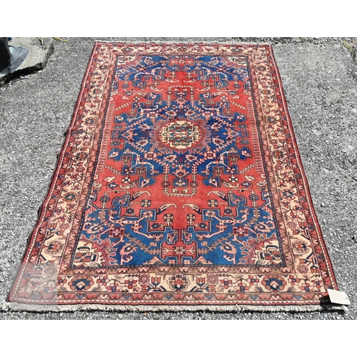 466 - A North West Persian Tafresh rug, the red ground centred by a blue floral medallion, 200 cm x 130 cm