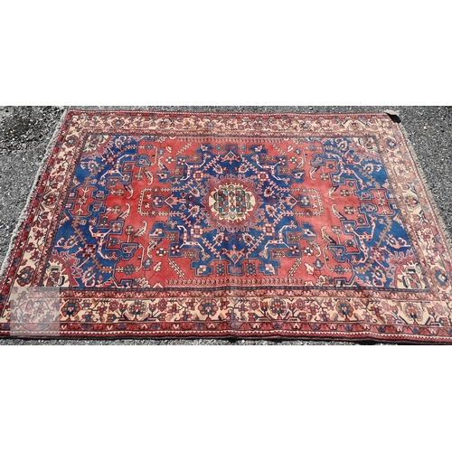 466 - A North West Persian Tafresh rug, the red ground centred by a blue floral medallion, 200 cm x 130 cm