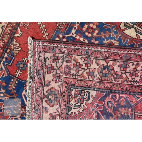466 - A North West Persian Tafresh rug, the red ground centred by a blue floral medallion, 200 cm x 130 cm