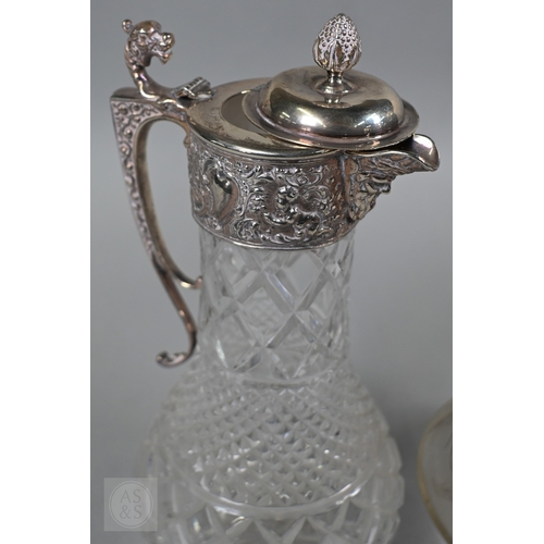 1 - A heavy quality cut glass claret jug with embossed and chased silver collar, cover and handle, C J V... 