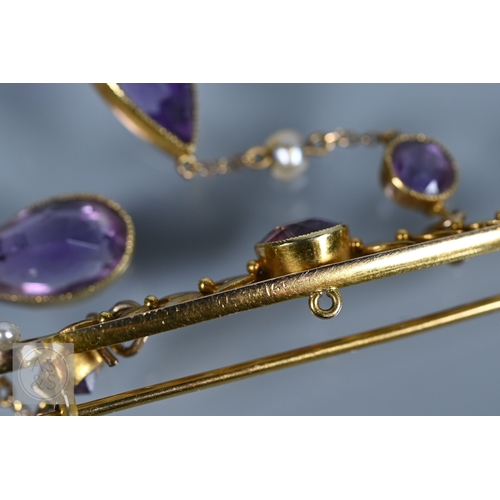252 - An Edwardian yellow gold brooch set amethyst and seed pearls, with two chain linked amethyst and see... 
