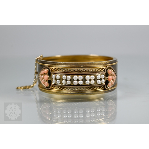 253 - A Victorian bloomed gold oval half-hinged bangle, the frontispiece set with five squares of four see... 