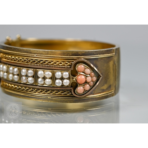 253 - A Victorian bloomed gold oval half-hinged bangle, the frontispiece set with five squares of four see... 
