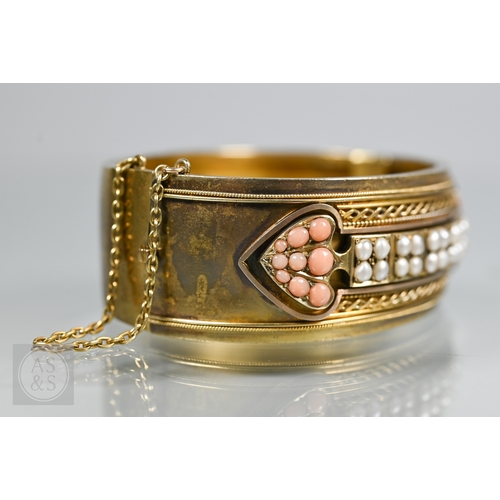 253 - A Victorian bloomed gold oval half-hinged bangle, the frontispiece set with five squares of four see... 