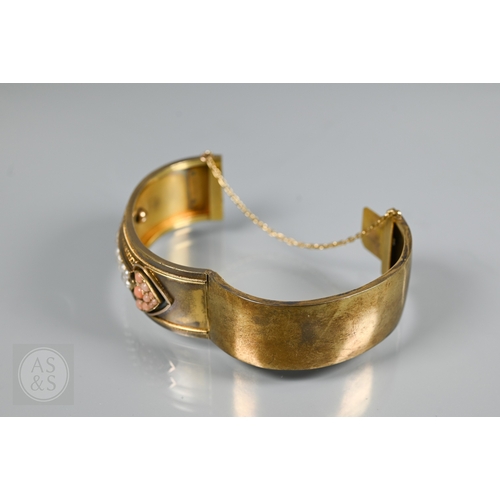 253 - A Victorian bloomed gold oval half-hinged bangle, the frontispiece set with five squares of four see... 