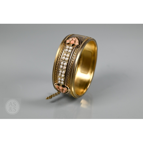 253 - A Victorian bloomed gold oval half-hinged bangle, the frontispiece set with five squares of four see... 