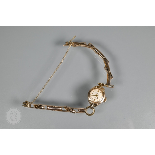273 - A 9ct yellow gold lady's wristwatch with bracelet strap, a Sekonda watch face, enamelled religious p... 
