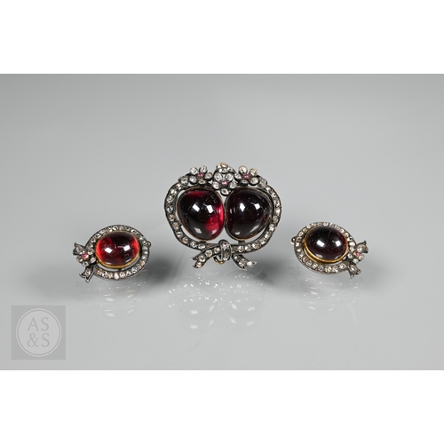 274 - A Victorian suite of three diamond and garnet brooches, the centrepiece comprising two cabochon garn... 