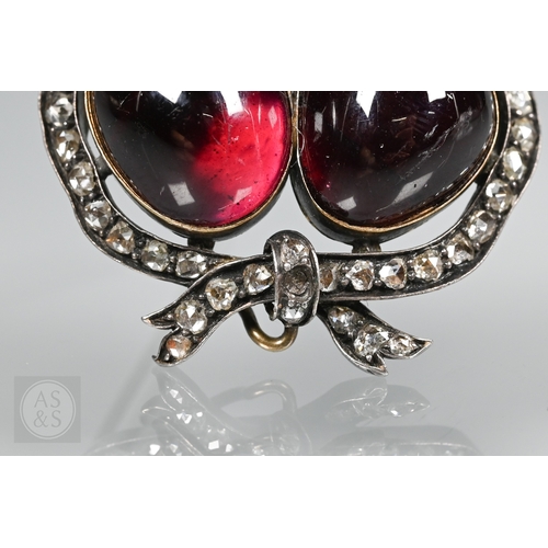 274 - A Victorian suite of three diamond and garnet brooches, the centrepiece comprising two cabochon garn... 