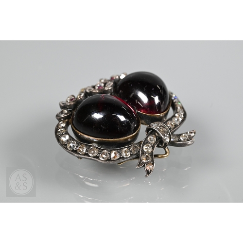 274 - A Victorian suite of three diamond and garnet brooches, the centrepiece comprising two cabochon garn... 