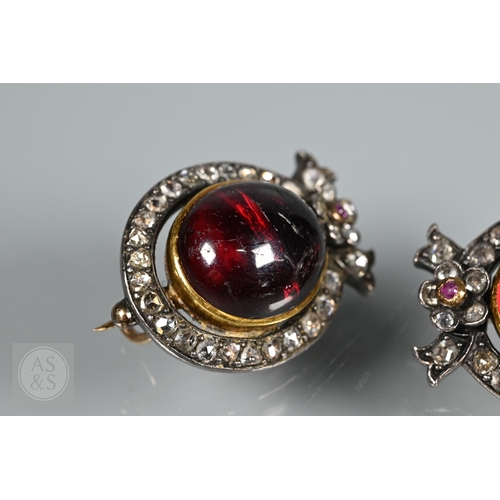 274 - A Victorian suite of three diamond and garnet brooches, the centrepiece comprising two cabochon garn... 
