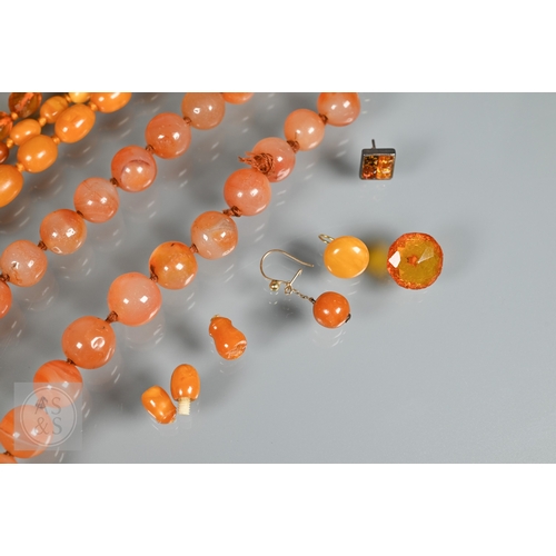 275 - A triple row of graduated amber beads, comprising two 'butterscotch opaque' and one faceted, double ... 