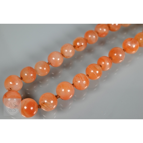 275 - A triple row of graduated amber beads, comprising two 'butterscotch opaque' and one faceted, double ... 
