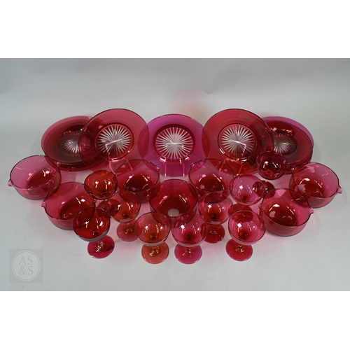 469 - A set of nine 19th Century cranberry glass champagne saucers with clear stems and ground-out pontil ... 
