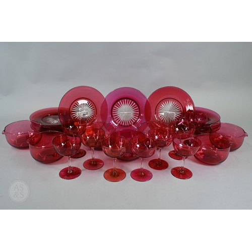 469 - A set of nine 19th Century cranberry glass champagne saucers with clear stems and ground-out pontil ... 