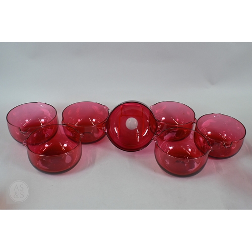 469 - A set of nine 19th Century cranberry glass champagne saucers with clear stems and ground-out pontil ... 