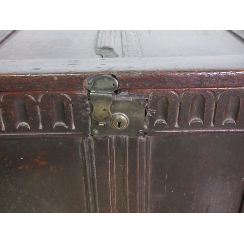 207 - A 17th Century oak Coffer, sunken four panel lid, four panel front, nulled carved frieze, later lock... 