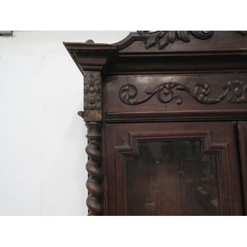 25 - A Continental carved oak glazed Bookcase.