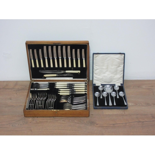 251 - An oak cased Canteen of Cutlery and a case set of scallop shaped Spoons.