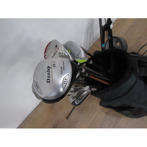 407 - A bag of Dunlop Golf Clubs with Trolley and an oil filled Radiator.