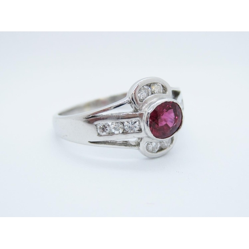 529 - A Ruby and Diamond Ring rubover-set oval-cut ruby within channel-set brilliant-cut diamonds in 18ct ... 