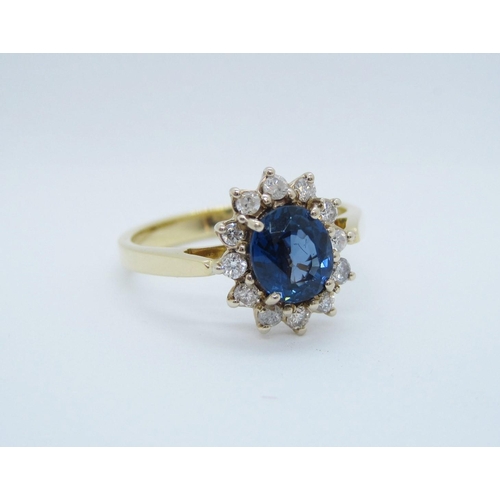 541 - A Sapphire and Diamond Cluster Ring claw-set oval-cut sapphire within frame of twelve brilliant-cut ... 