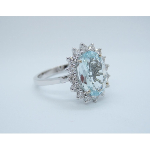 545 - An Aquamarine and Diamond Cluster Ring claw-set oval-cut aquamarine, 3.20cts, within a frame of bril... 