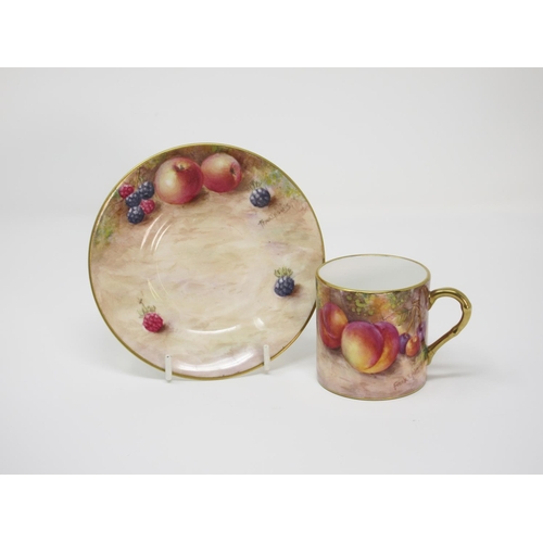 551 - An ORB Coffee Can and Saucer, painted fruit, signed Frank T Higgins.