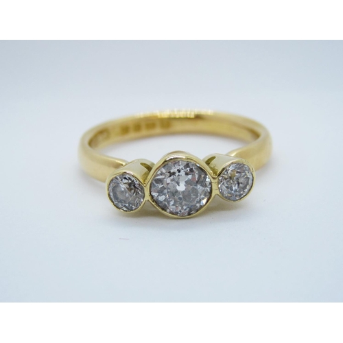 564 - A Diamond three stone Ring, rubover-set graduated old-cut stones in 22ct gold, ring size S.