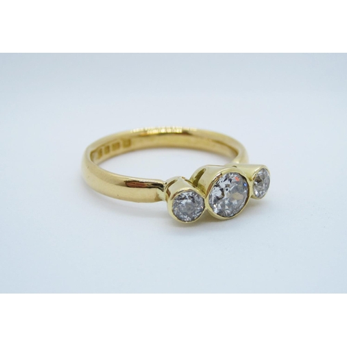 564 - A Diamond three stone Ring, rubover-set graduated old-cut stones in 22ct gold, ring size S.