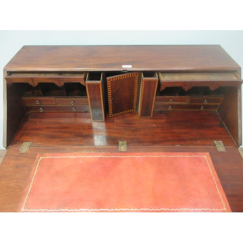 95 - A George III mahogany Bureau with sloping fall front enclosing a boxwood inlaid fitted interior abov... 