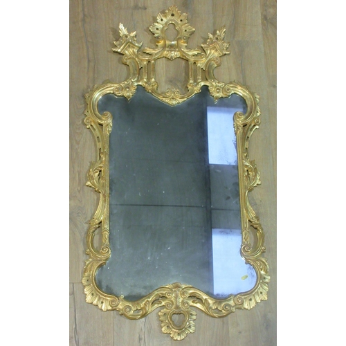 481 - An 18th Century Rococco influence gilt framed Wall Mirror with raised acanthus leaf and bouquet surm... 