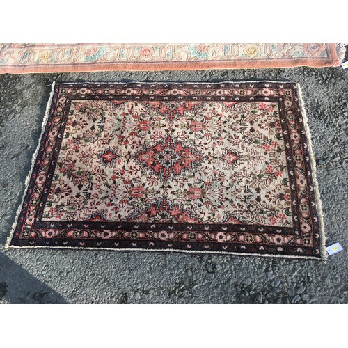 7 - A pink ground Chinese Rug with stylised floral decoration 8ft 4in L X 5ft 6in W, a small cream groun... 