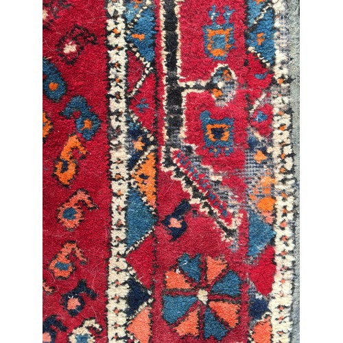 11 - A red ground woollen Rug 8ft 1in L x 5ft 7in W and another with blue waisted centre 5ft 9in L x 4ft ... 