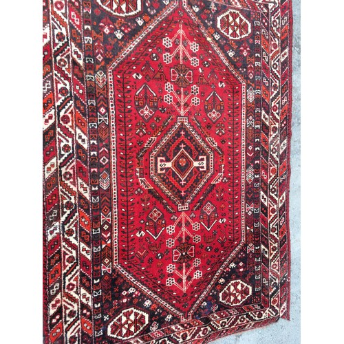 11 - A red ground woollen Rug 8ft 1in L x 5ft 7in W and another with blue waisted centre 5ft 9in L x 4ft ... 