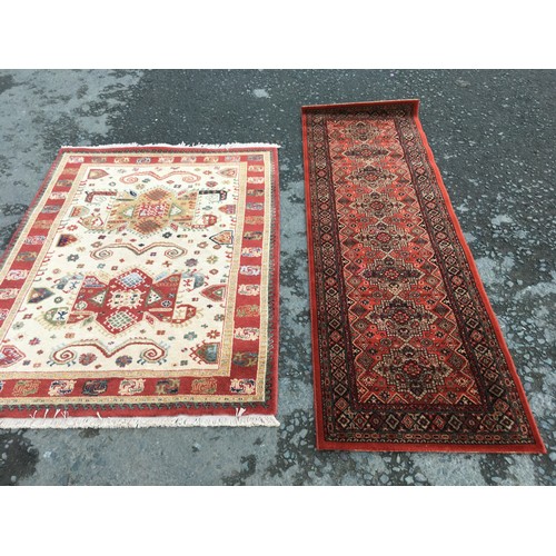 12 - A modern cream ground Rug with red border 6ft 4in L x 4ft 6in W and a red ground Runner 8ft 2in L x ... 